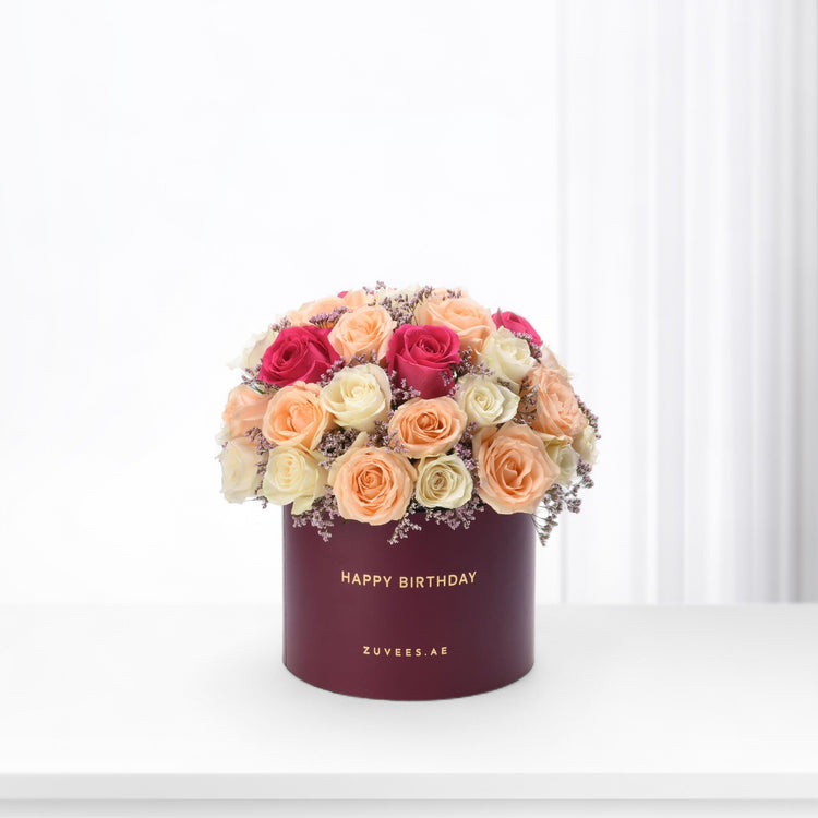 Vibrant multi-toned roses in burgundy box with "Happy Birthday" text.