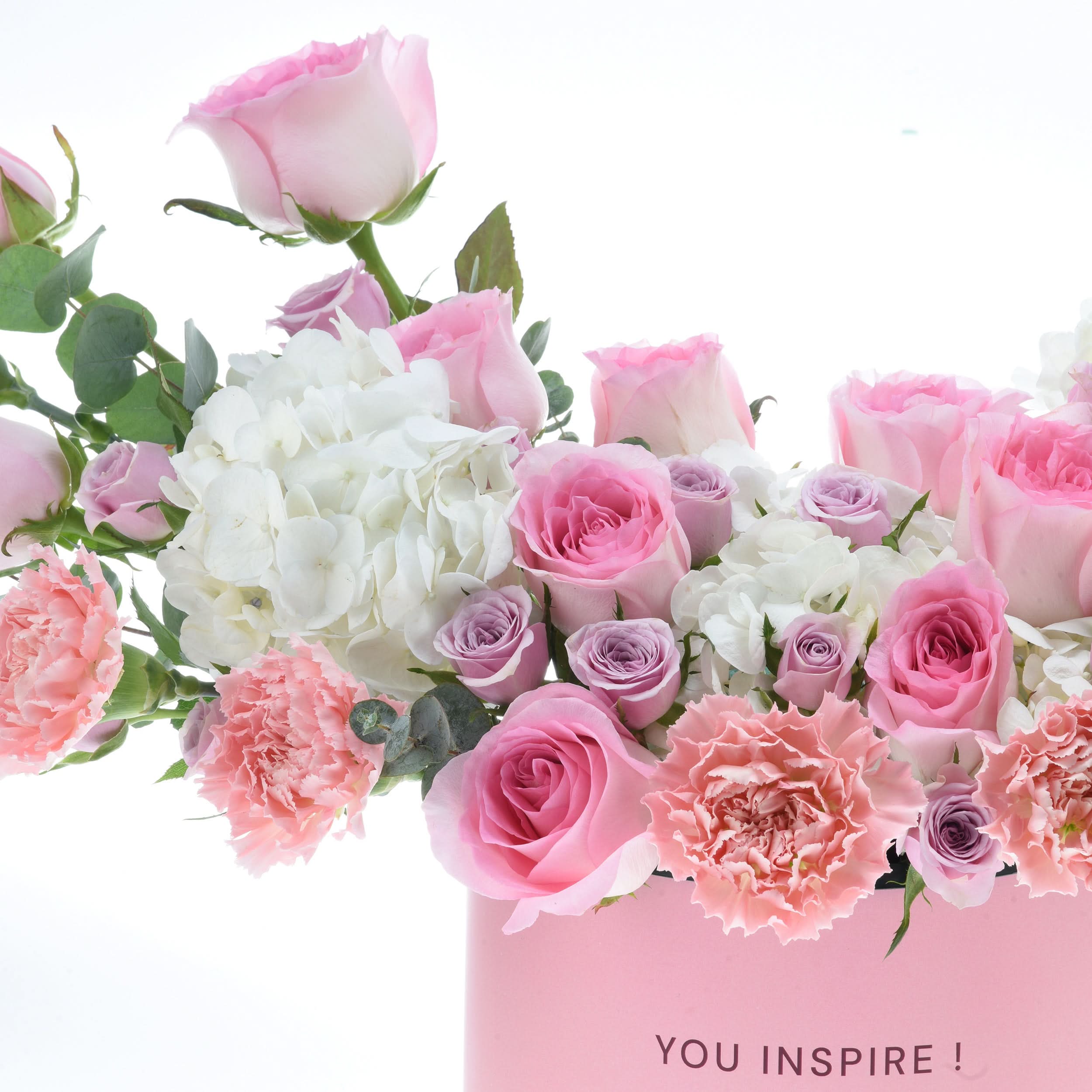 Pink roses, white hydrangeas, carnations in pink box with "YOU INSPIRE!" text.