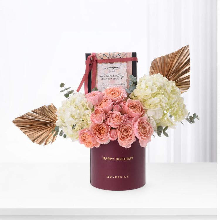 Elegant burgundy birthday bouquet with pink roses, cream hydrangeas, and gold accents.