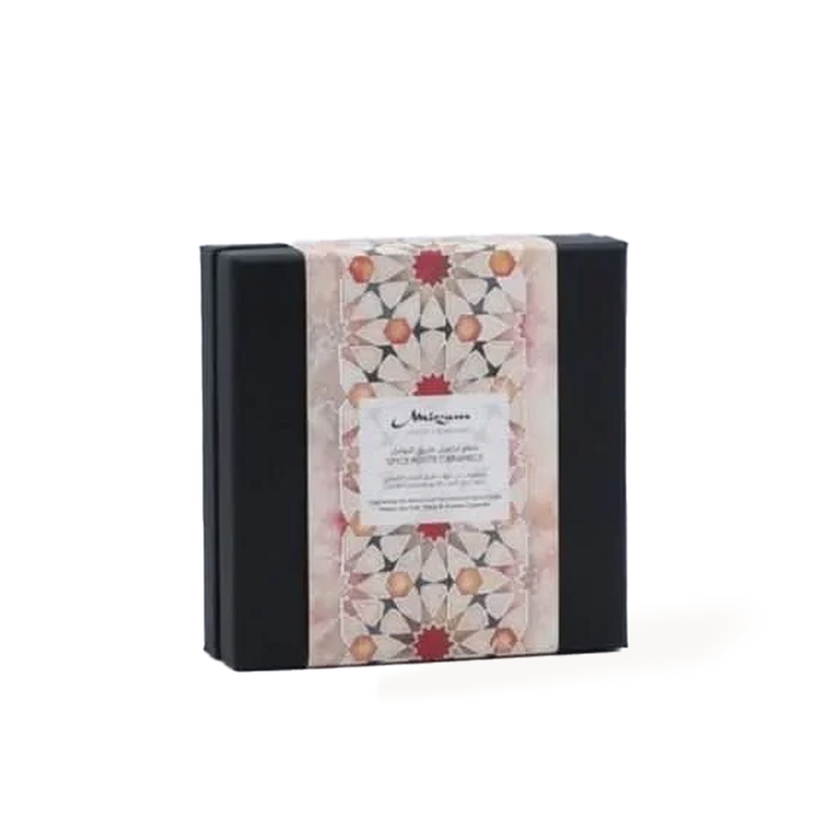 Elegant black box with ornate pink and red geometric patterned label.