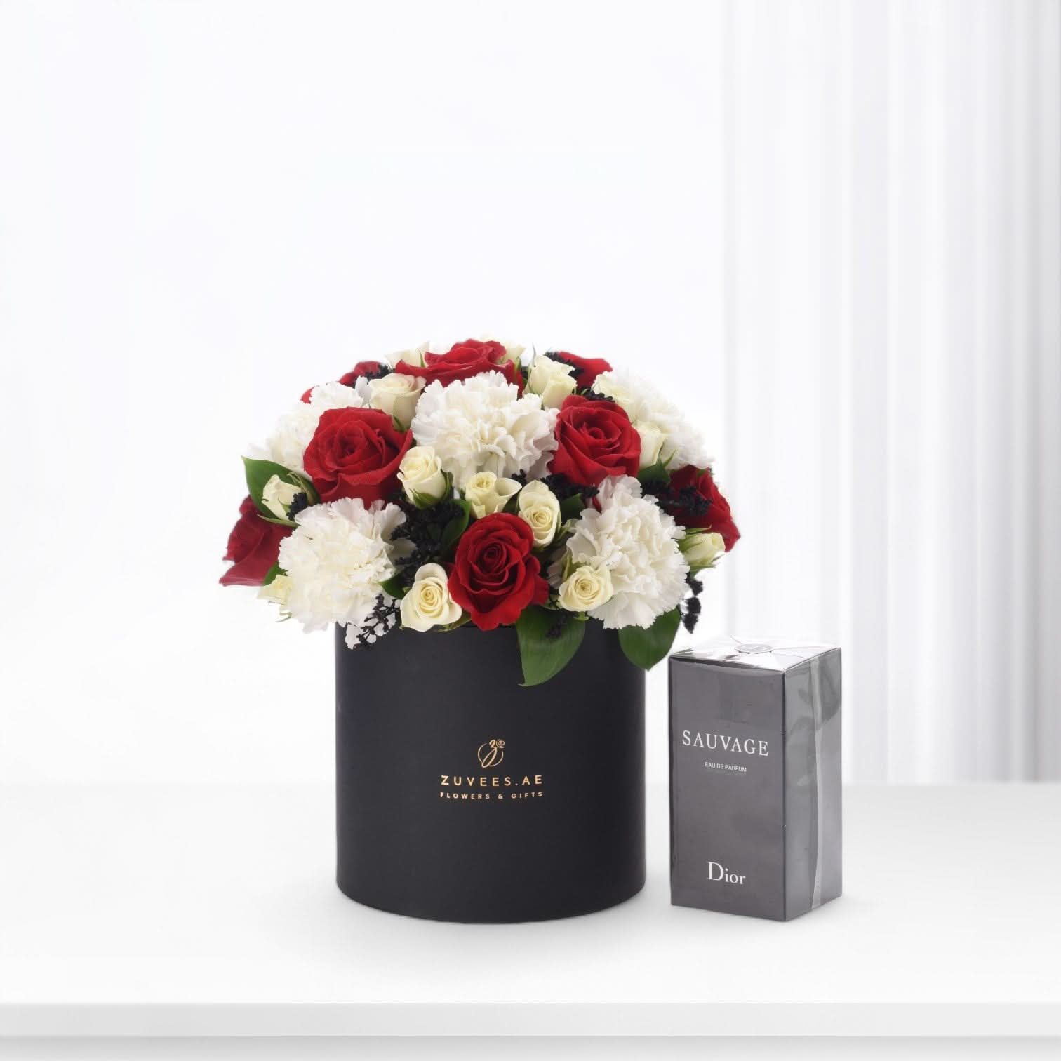 Red and white roses with carnations in black Zuvees box, paired with Dior Sauvage perfume.