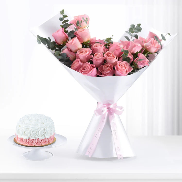 Pink roses and cake set, elegantly wrapped in white paper with pink ribbon.
