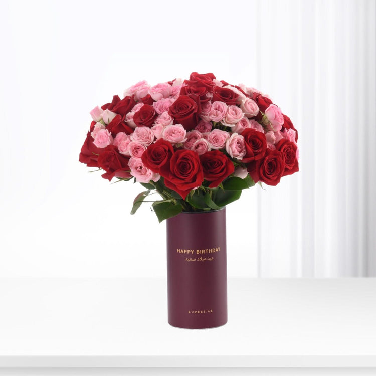 Luxurious red and pink roses in burgundy "Happy Birthday" vase, elegant gift for celebrations.
