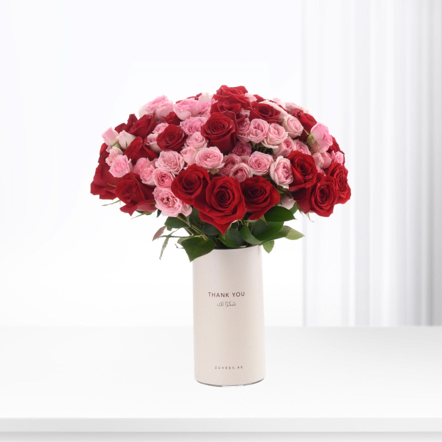 Red and pink roses in white vase, "Thank You" text, elegant gift bouquet.