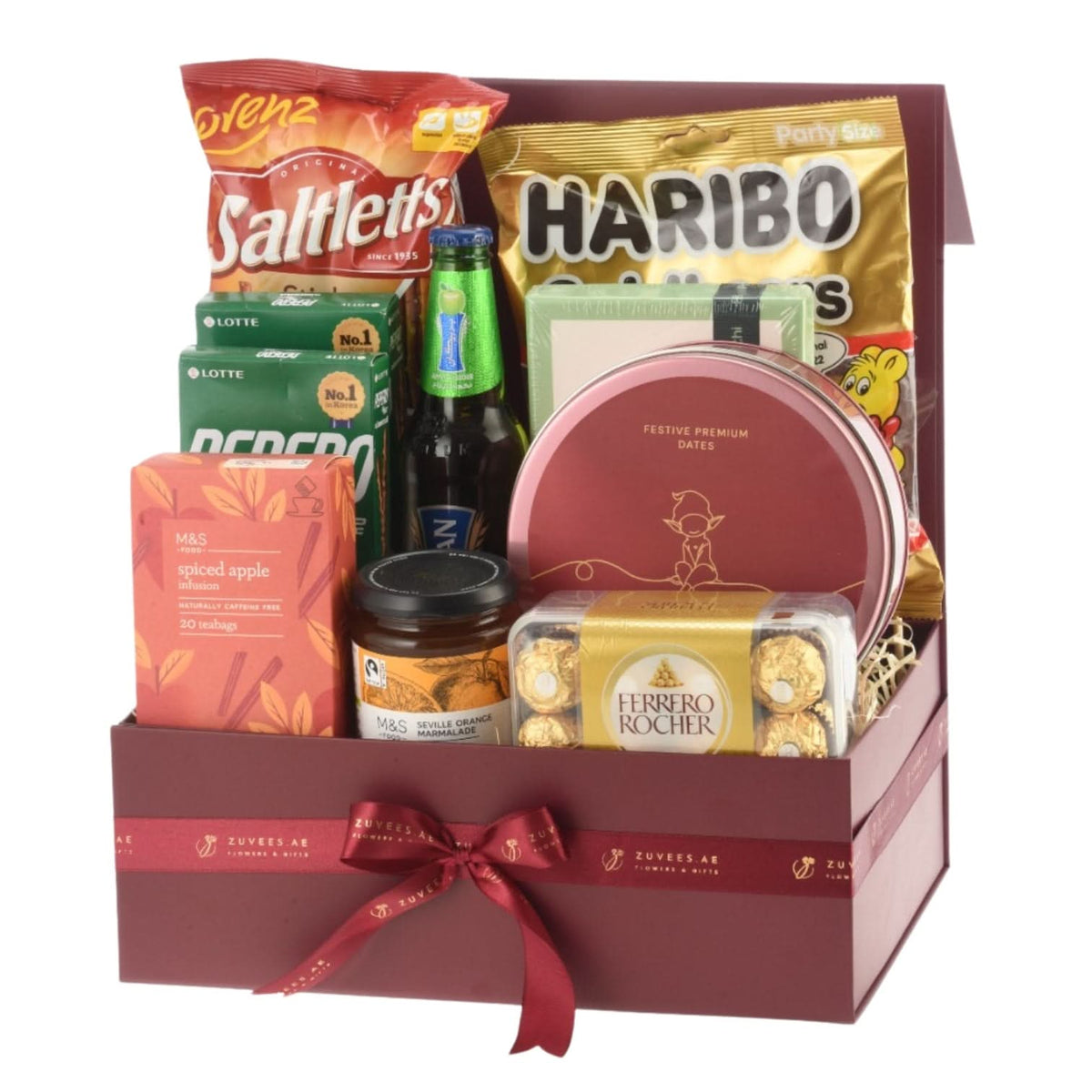 Luxury gift basket with Ferrero Rocher, Haribo, Saltletts, tea, marmalade, dates, and beer in burgundy box.