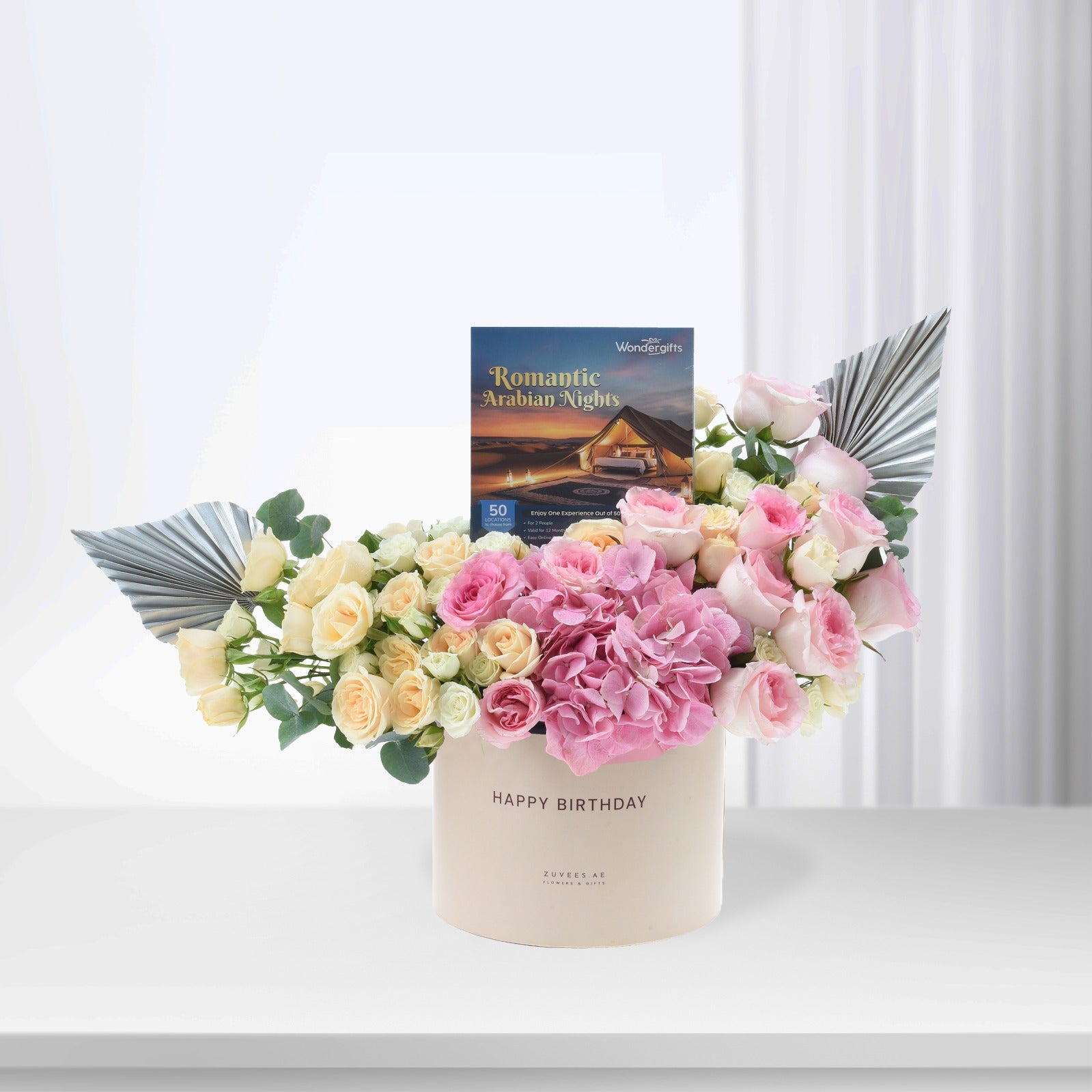 Pastel pink and cream roses with hydrangeas, silver fan accents, and "Happy Birthday" box.