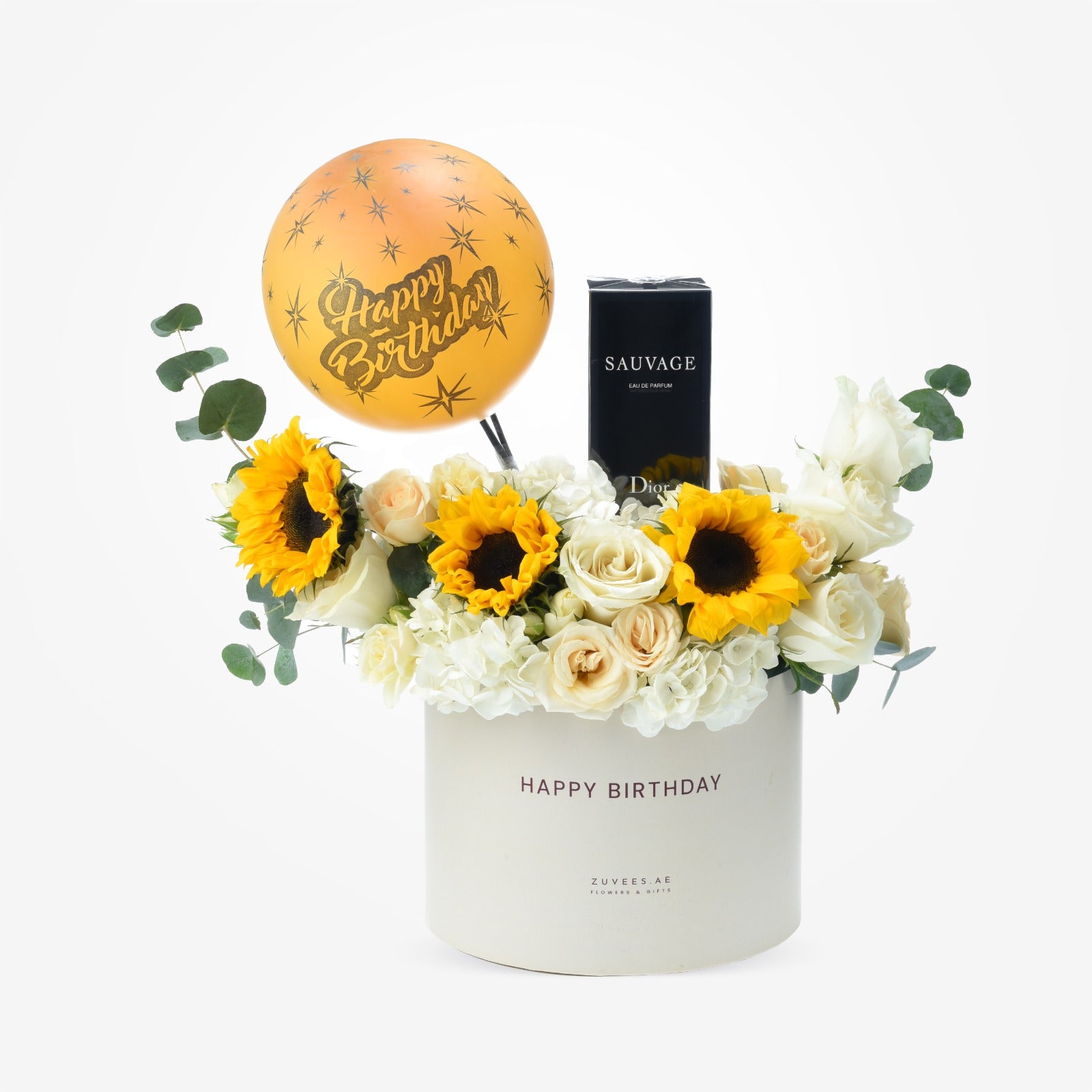 White box holds sunflowers, roses, and Dior perfume with golden birthday balloon.