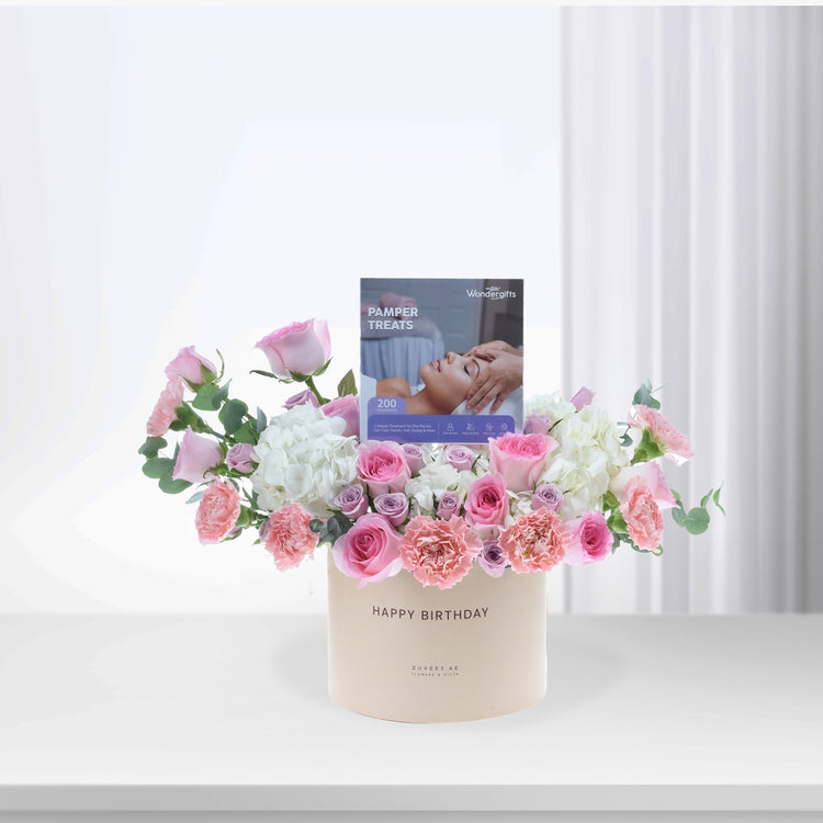 Soft pink roses and hydrangeas in cream vase with "Happy Birthday" and pamper treats card.