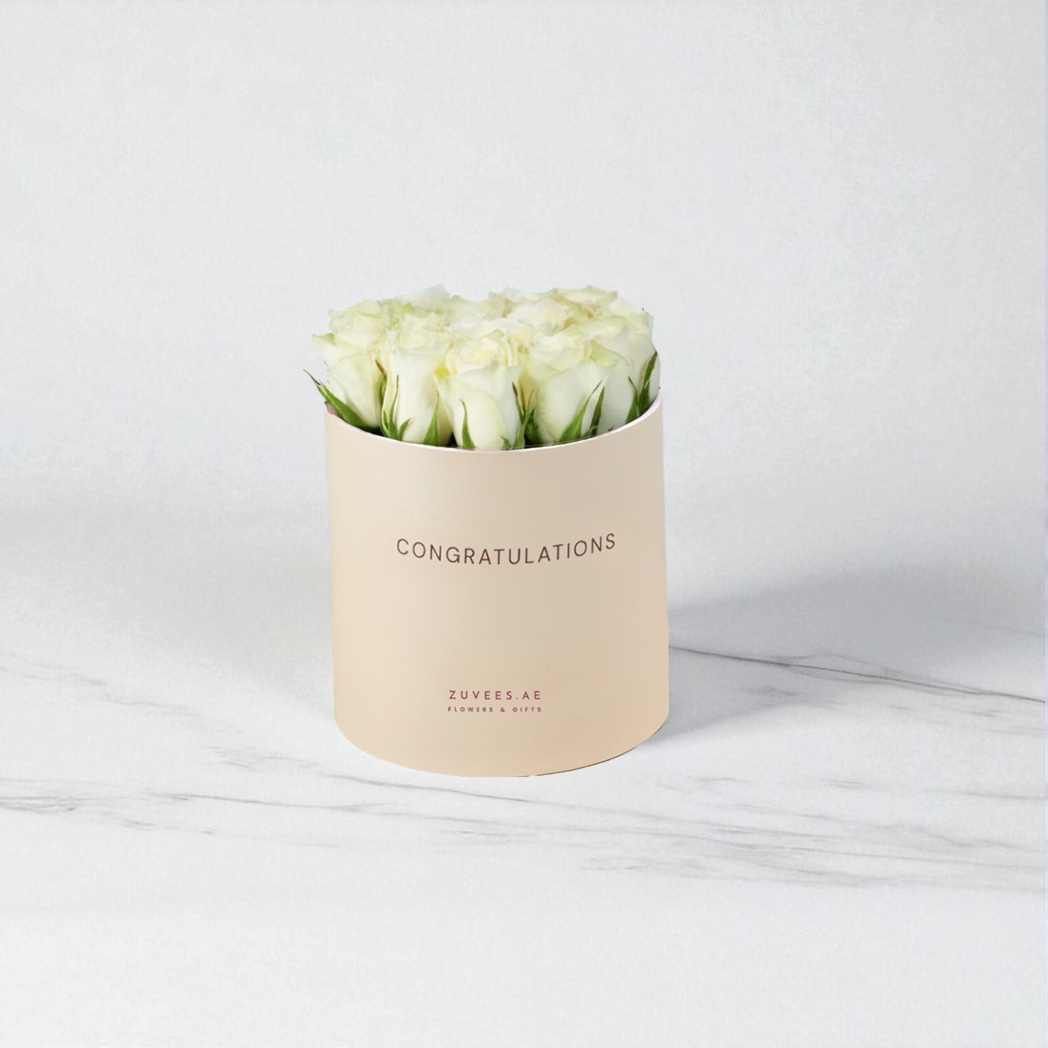Cream box holds pristine white roses, "Congratulations" printed elegantly.