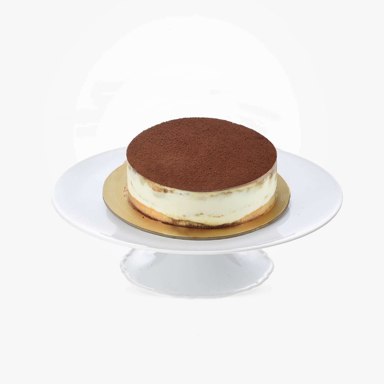 Rich chocolate-dusted tiramisu cake on elegant white pedestal stand.