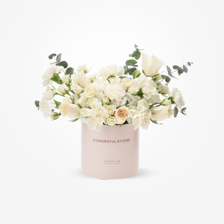 Elegant white rose and eucalyptus bouquet in blush "Congratulations" cylinder.