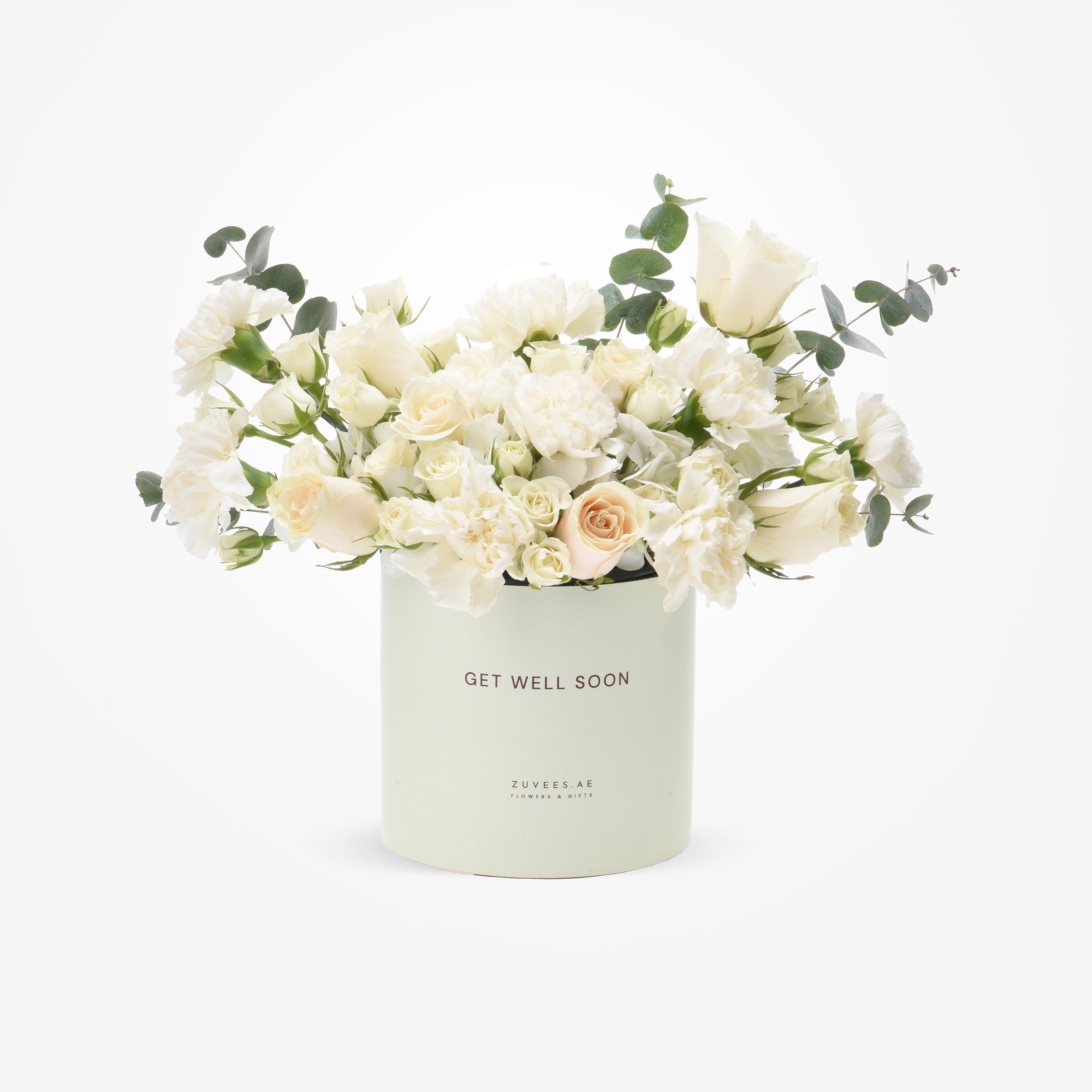 Soft white roses and eucalyptus in mint "Get Well Soon" cylinder.