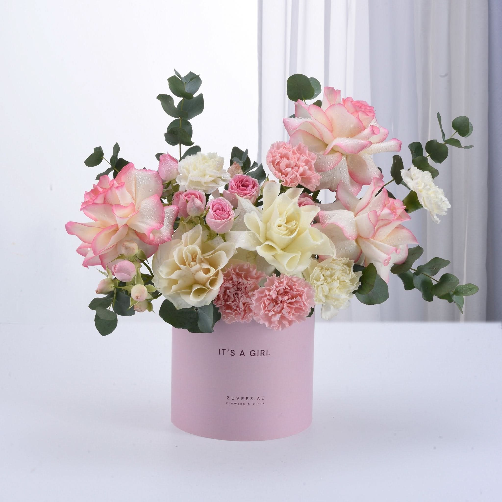 Soft pink and white roses, carnations, and eucalyptus in pastel pink "It&