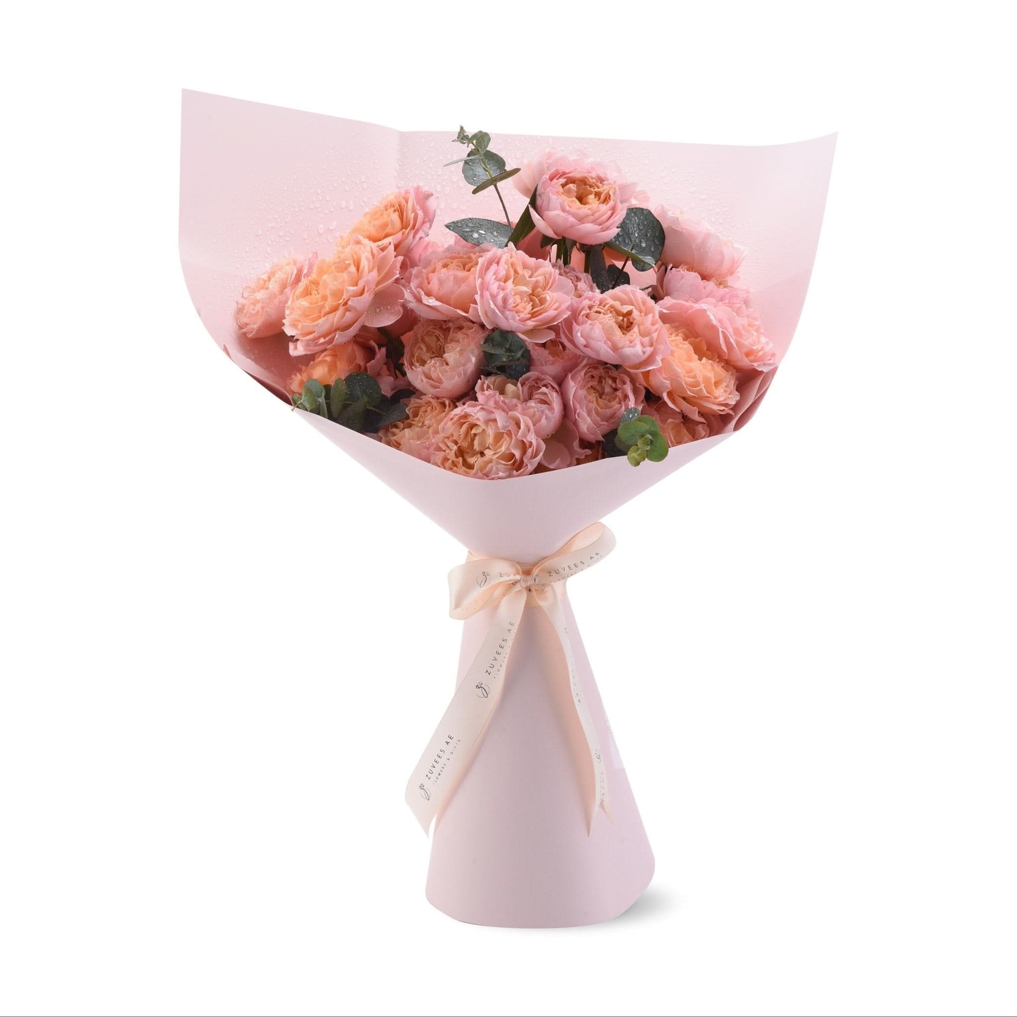 Soft pink roses with dewdrops, wrapped in matching paper and ribbon.