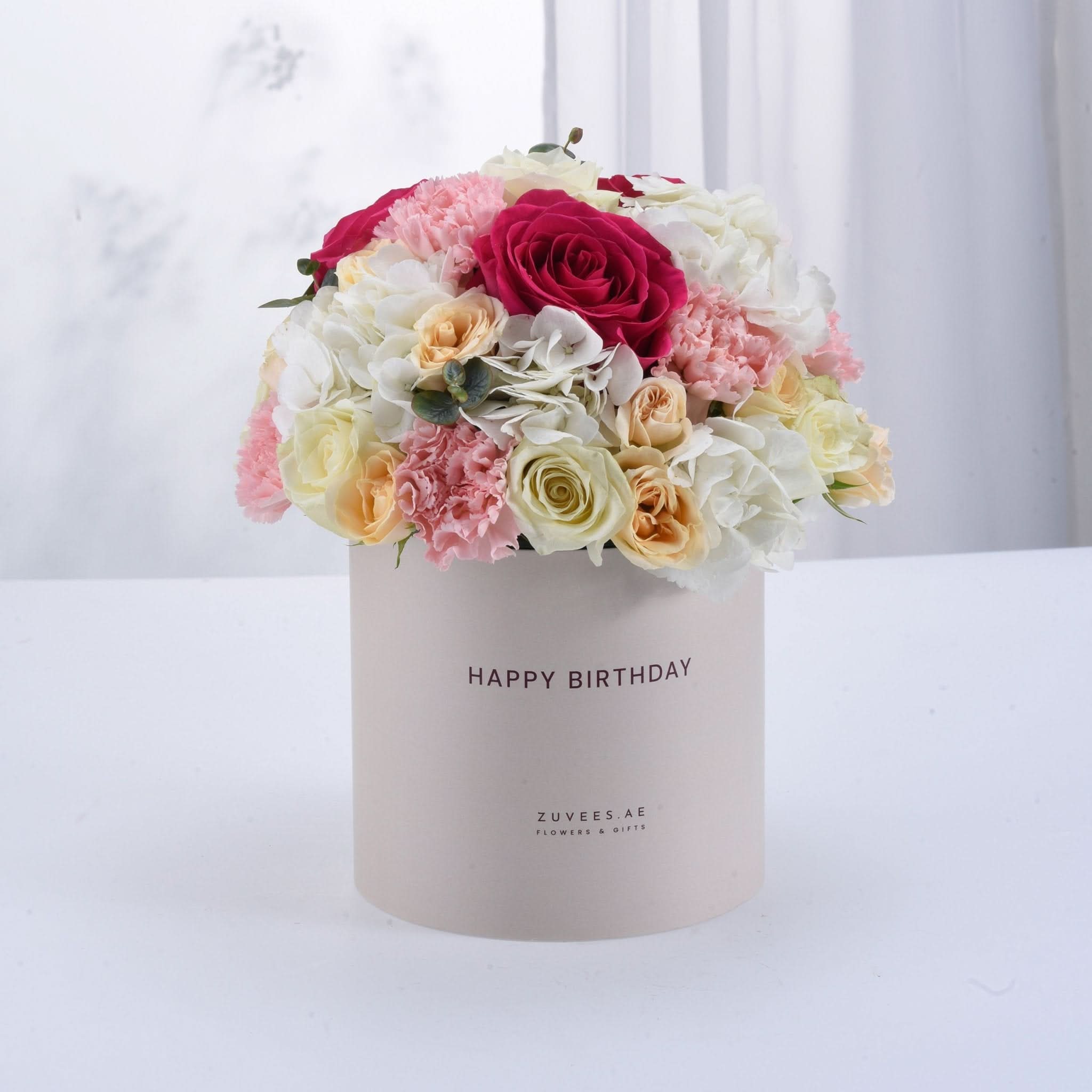 Pastel pink, white, and peach floral arrangement in a "Happy Birthday" box.