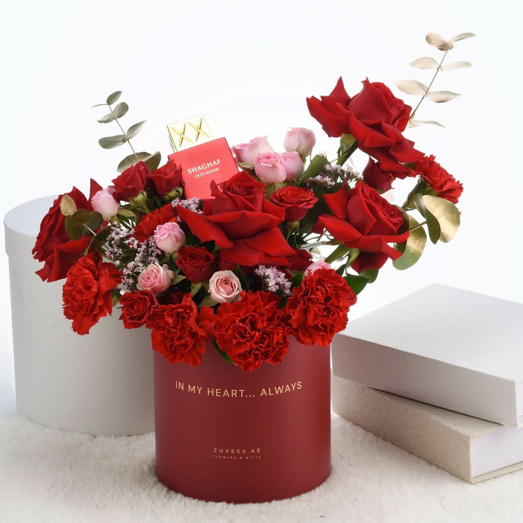 Vibrant red roses and carnations in elegant red box with "In My Heart... Always" inscription.