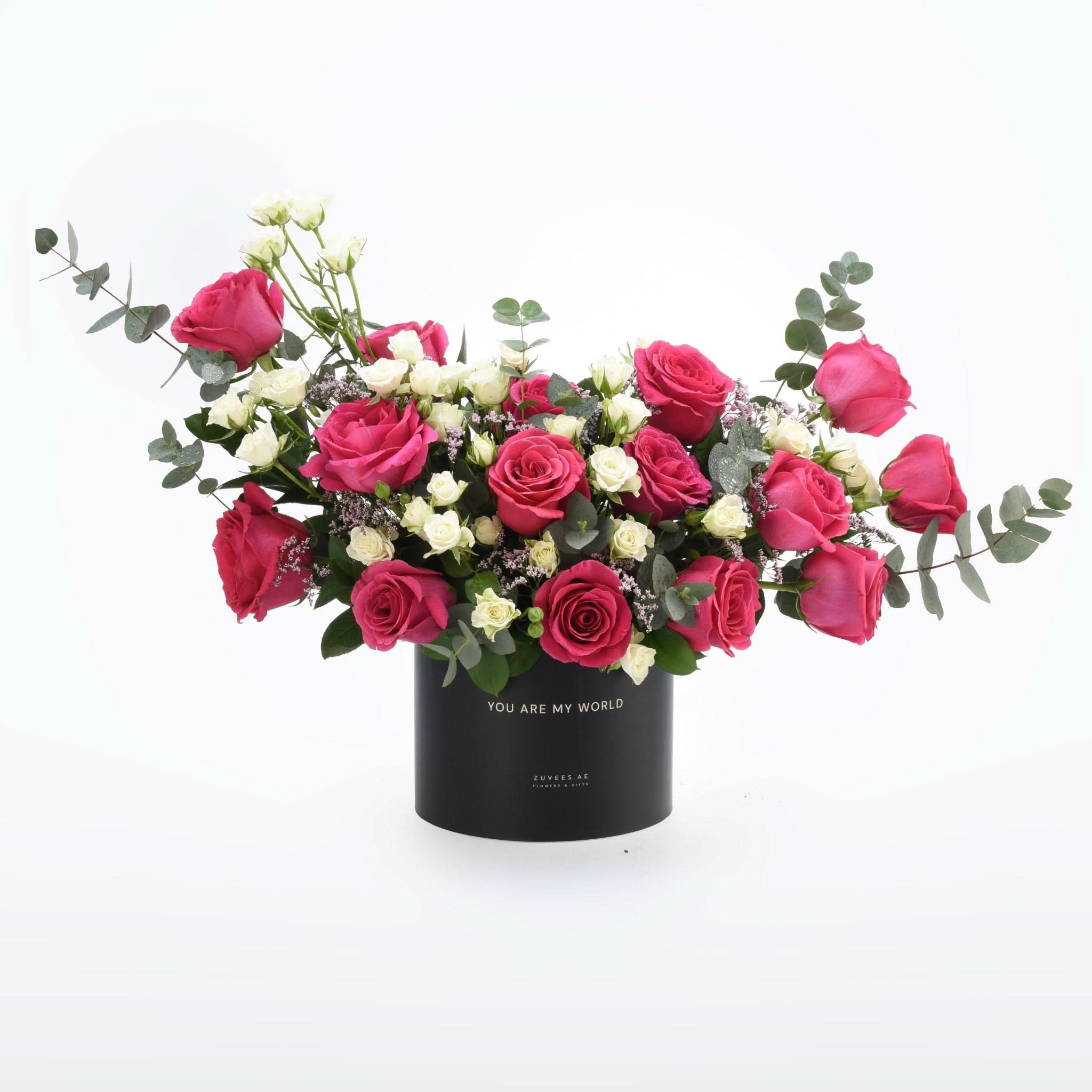 Vibrant pink and white roses in sleek black box with "You Are My World" inscription.