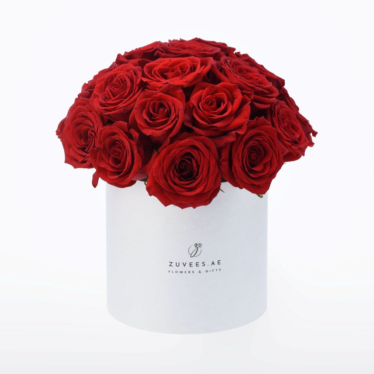 Vibrant red roses in sleek white box, elegant gift presentation.
