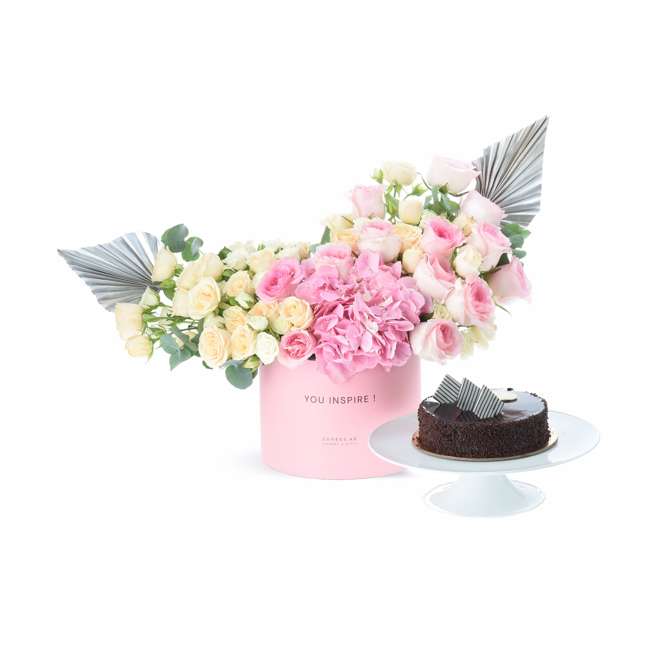 Pink floral arrangement with angel wings, paired with chocolate cake.