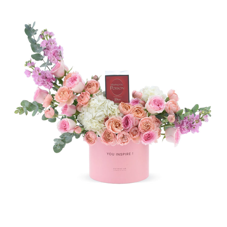 Pink floral arrangement with Dior perfume, eucalyptus, roses, hydrangeas in “YOU INSPIRE!” box.