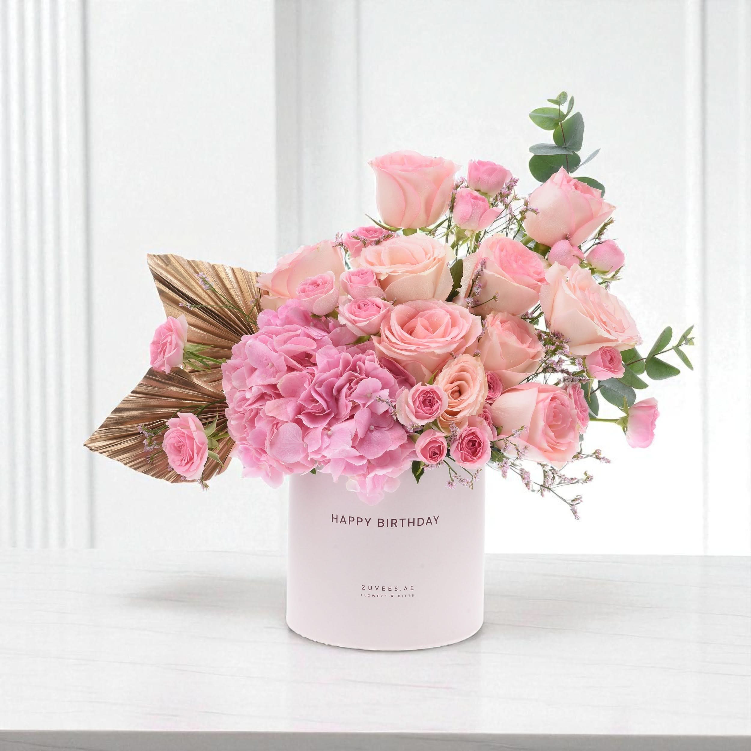 Soft pink roses and hydrangeas in a "Happy Birthday" box with gold leaf accent.