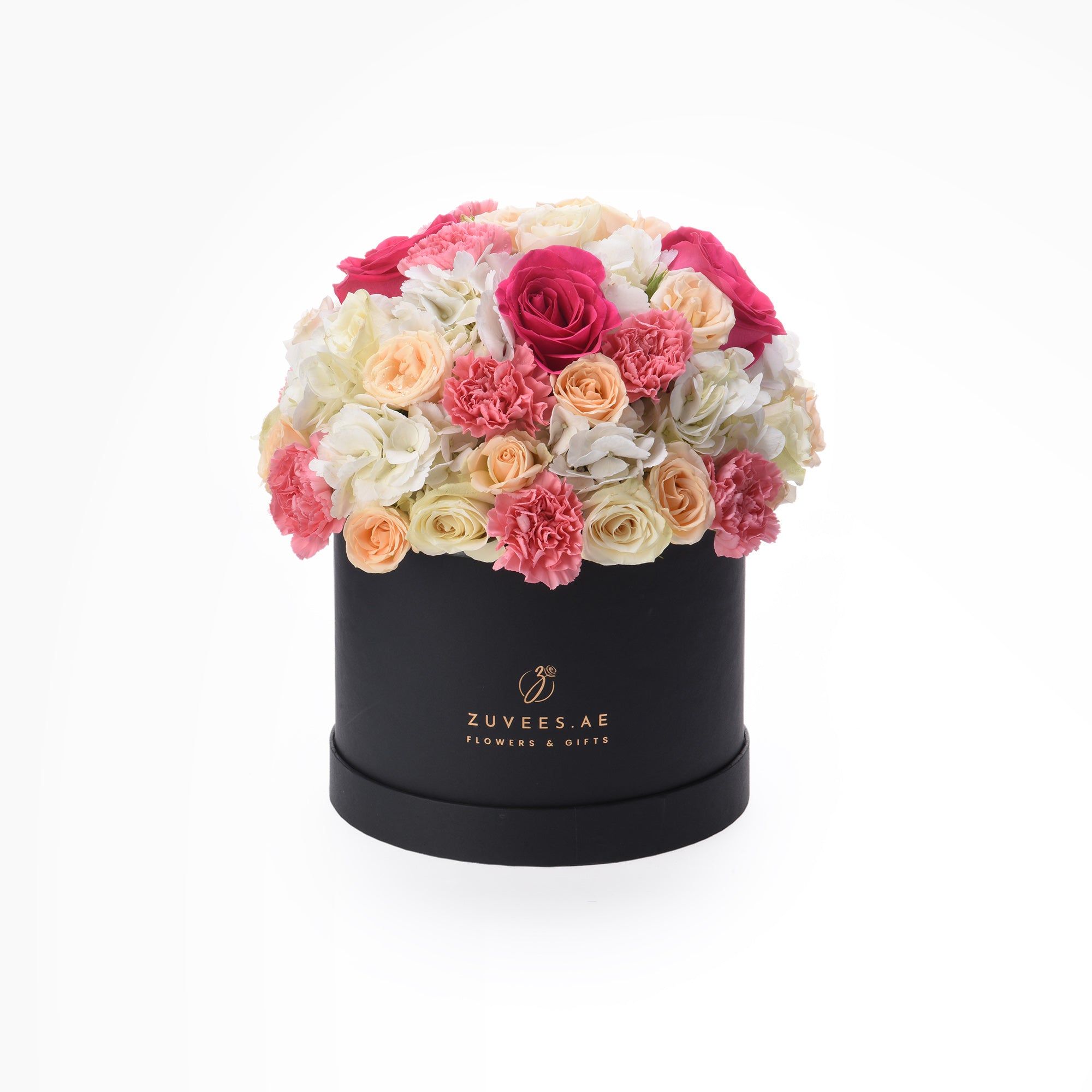 Elegant black hat box overflowing with vibrant pink, peach, and white roses and carnations.