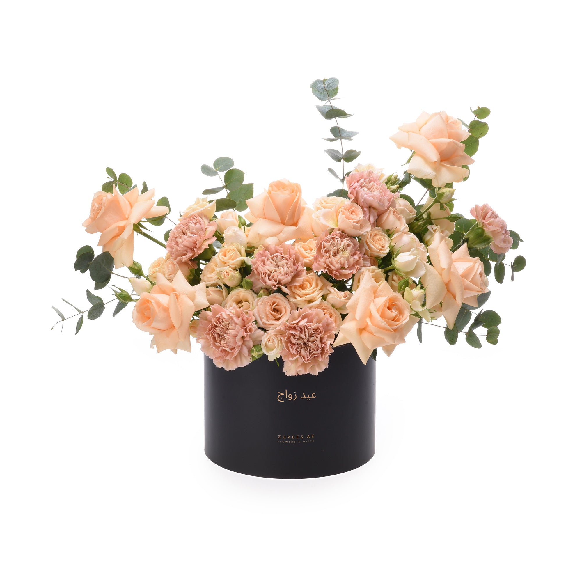 Elegant peach roses and carnations in sleek black box with gold script.