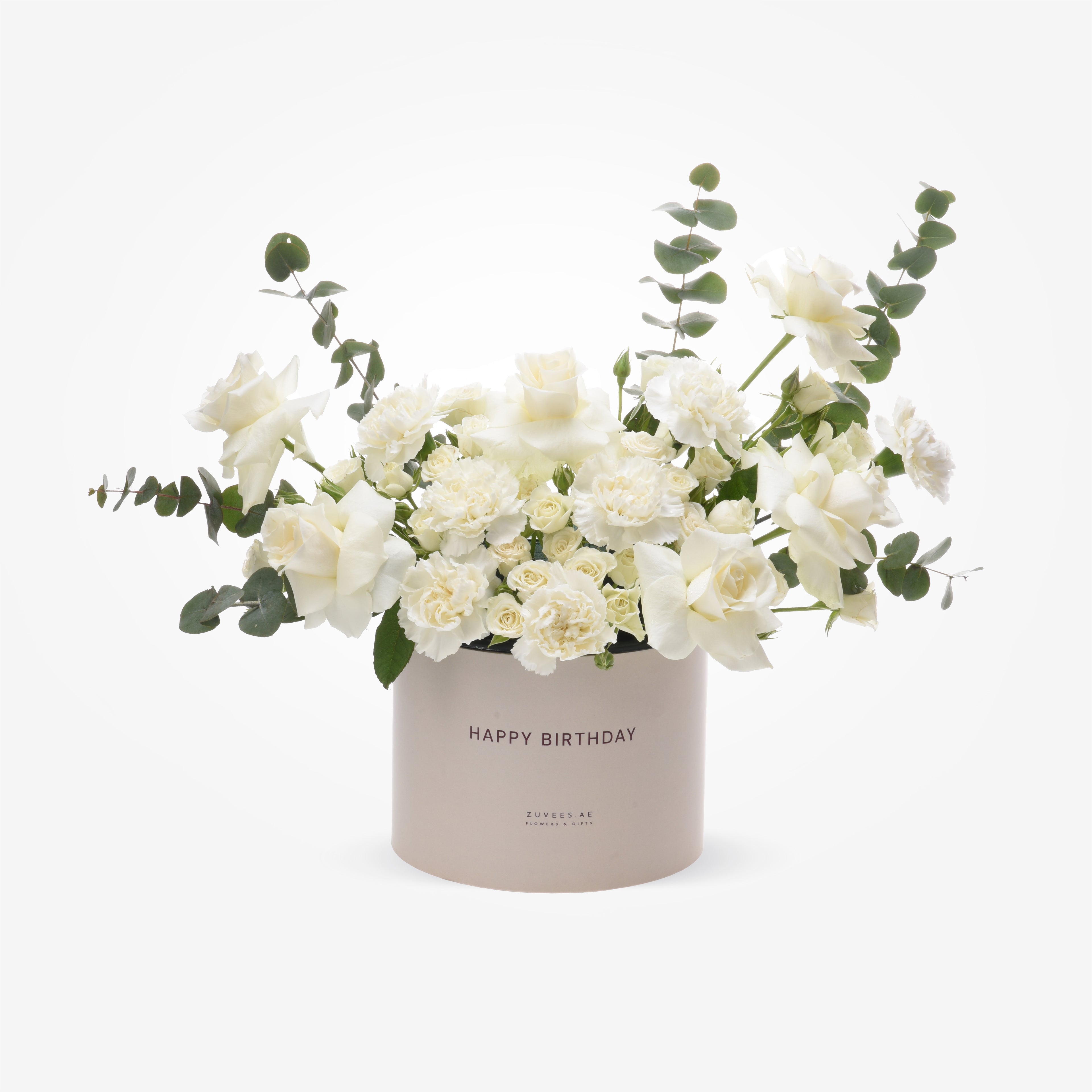 Elegant white roses and carnations in a blush "Happy Birthday" box with eucalyptus accents.