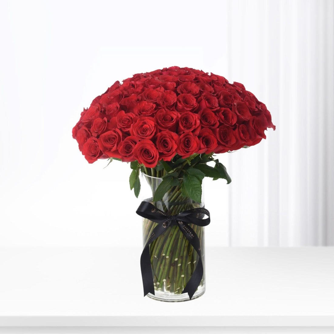 100 Red Roses In Glass Vase - Zuvees.ae