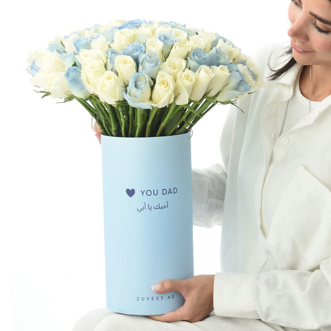 Woman holding a vase of 101 blue roses, Father&