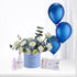 Blue balloon bouquet with white roses, Johnson’s baby essentials, and “It’s a Boy” gift box.
