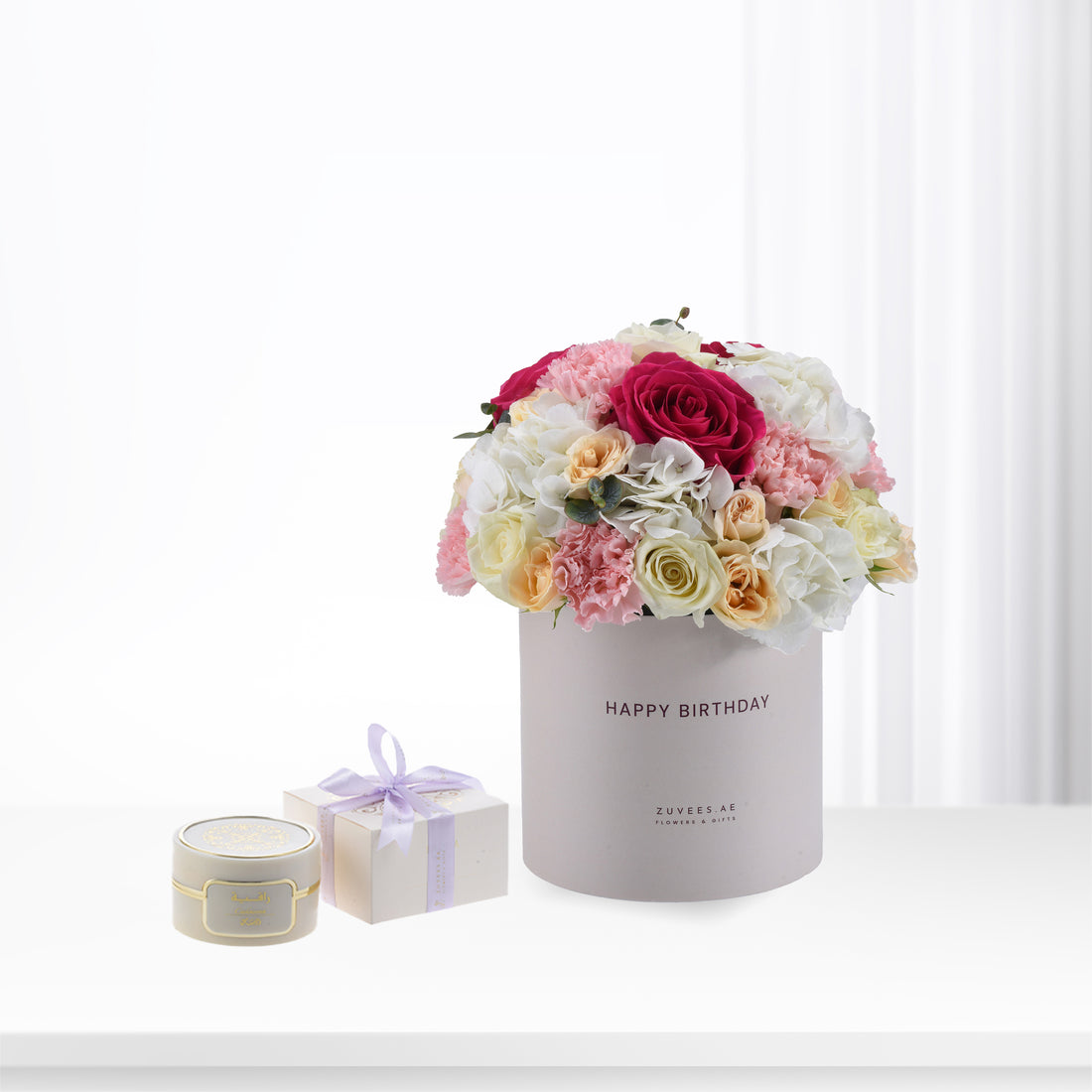 Elegant birthday bouquet in blush box, paired with luxury candle and gift.