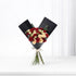 Elegant black-wrapped bouquet with red and cream roses, accented by eucalyptus and a white ribbon.