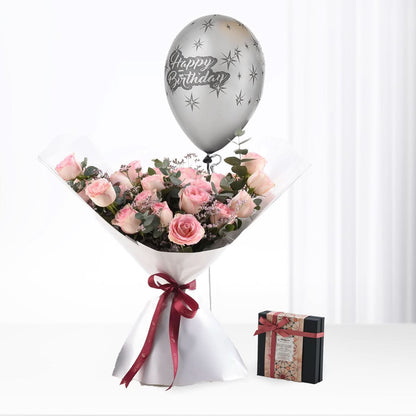 Pink roses, silver "Happy Birthday" balloon, and chocolate gift box.