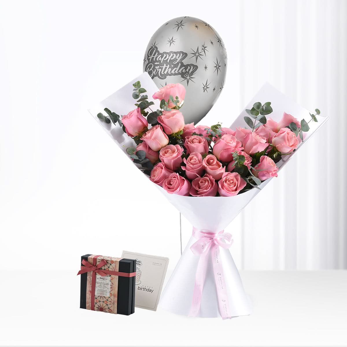 Pink roses bouquet with silver balloon and chocolate gift for birthday.