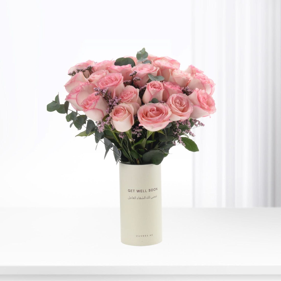 Soft pink roses in minimalist vase with "Get Well Soon" message.