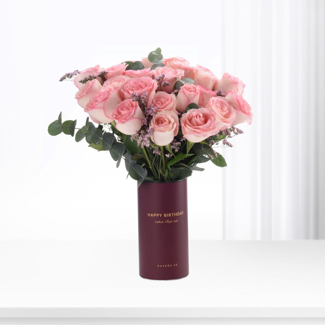 Pink roses in burgundy vase with "Happy Birthday" text, elegant gift arrangement.