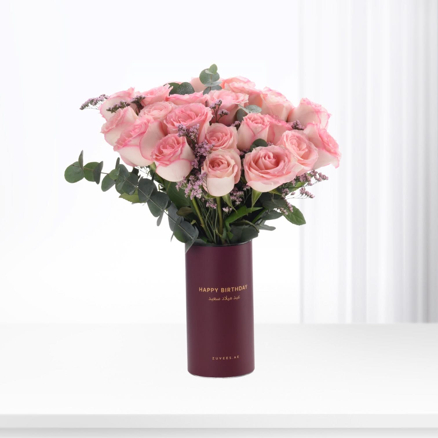 Pink roses in burgundy vase with "Happy Birthday" text, elegant gift arrangement.