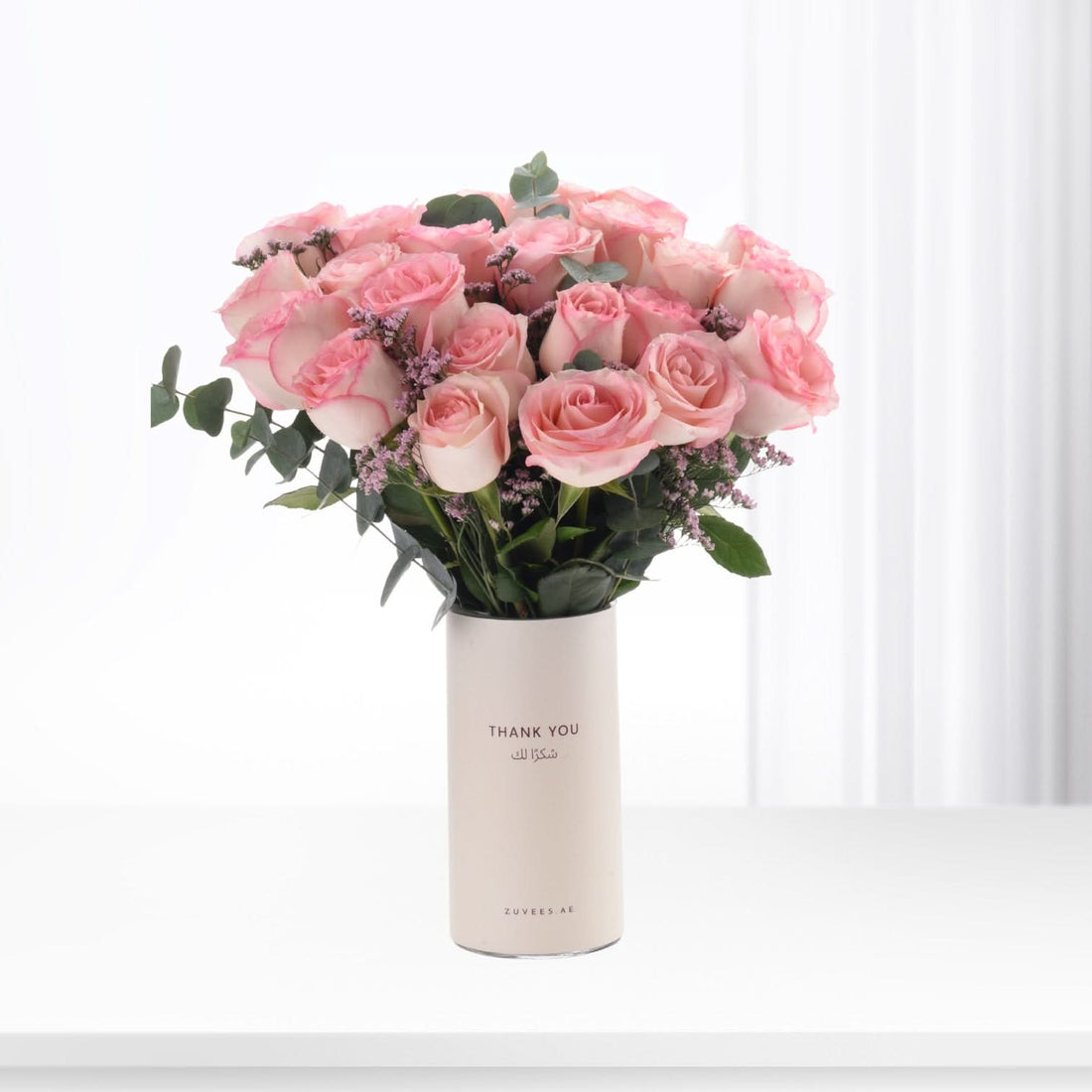 Soft pink roses in minimalist white vase with "Thank You" text.