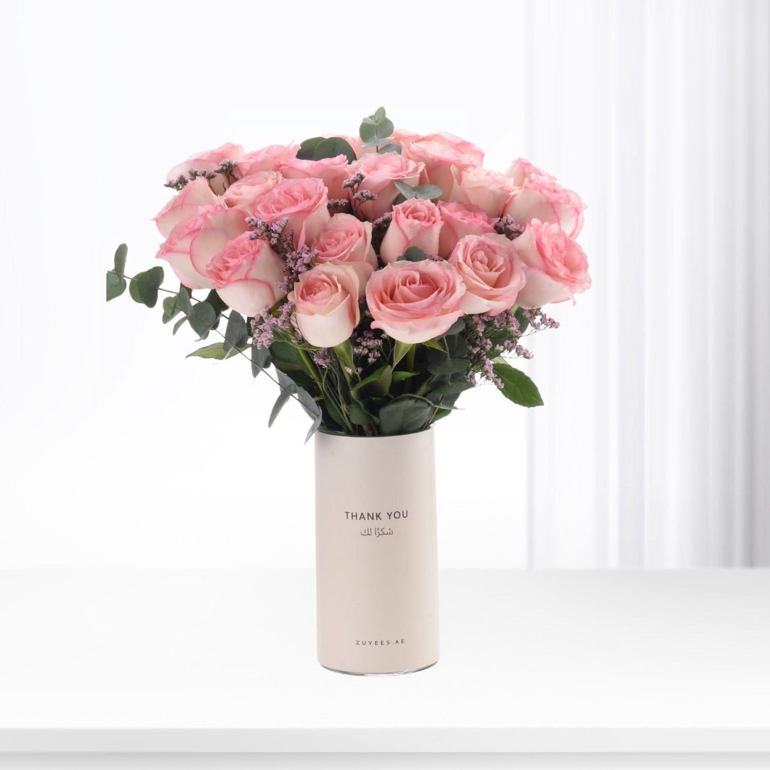 Soft pink roses in minimalist white vase with "Thank You" text.