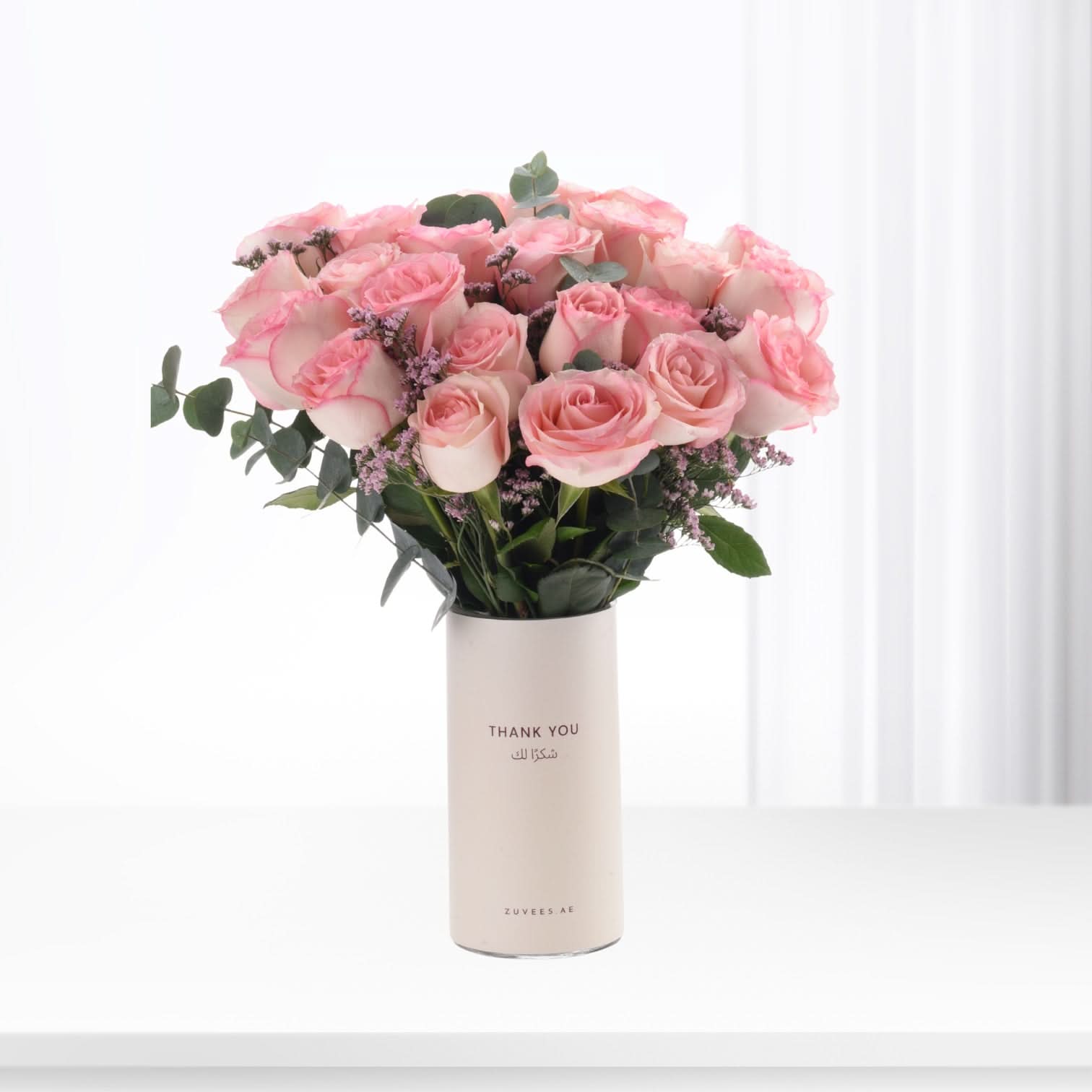 Soft pink roses in minimalist white vase with "Thank You" text.