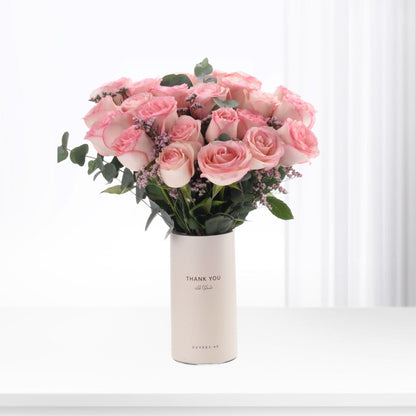 Soft pink roses in minimalist white vase with "Thank You" text.