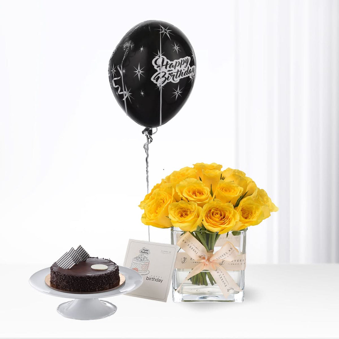 Black balloon, yellow roses, chocolate cake—birthday celebration bundle.