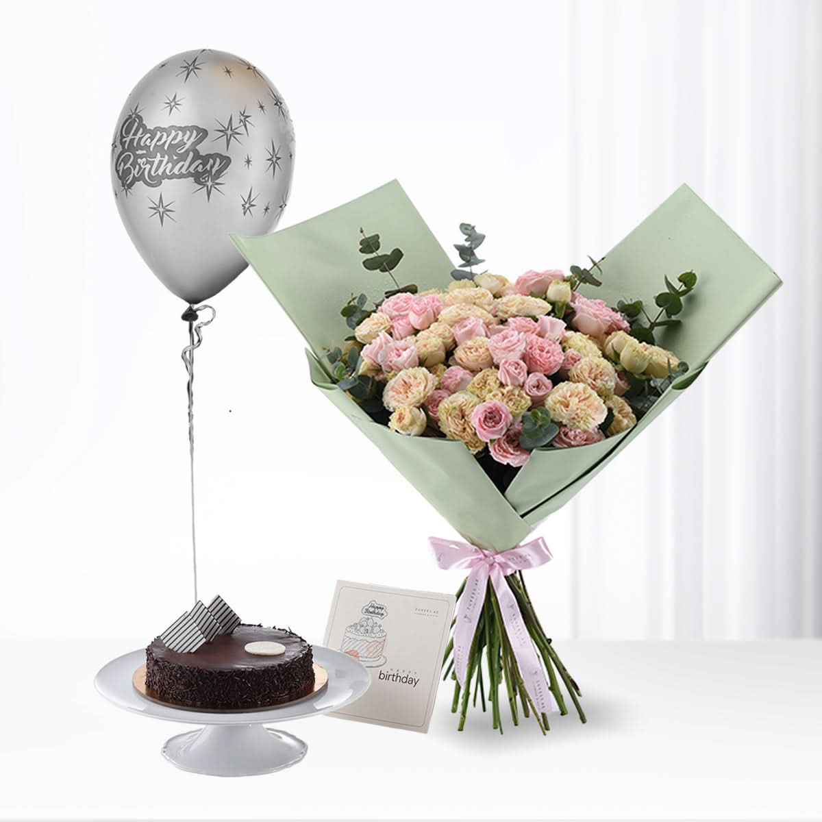 Pink rose bouquet, chocolate cake, silver "Happy Birthday" balloon, mint wrap, pink ribbon, greeting card.
