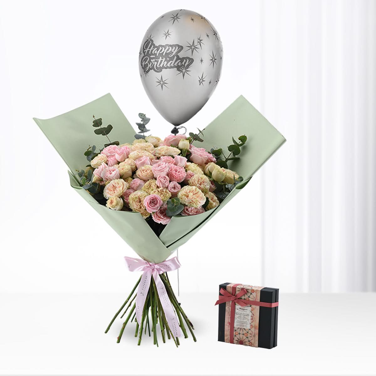 Pastel pink roses, silver "Happy Birthday" balloon, and chocolate box gift.