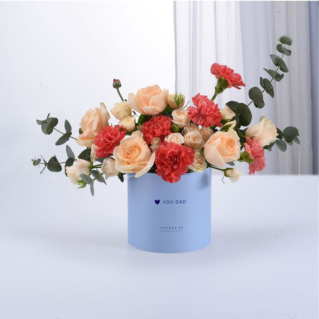 Soft peach roses and coral carnations in light blue "You Dad" gift box.