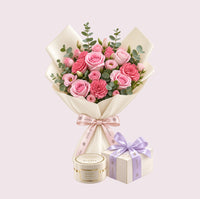 A heart-shaped bouquet of pink roses and carnations with green eucalyptus stems, wrapped in cream paper with a pink ribbon, accompanied by a small cream gift box with a purple ribbon and a round cream tin, all on a pale pink background.