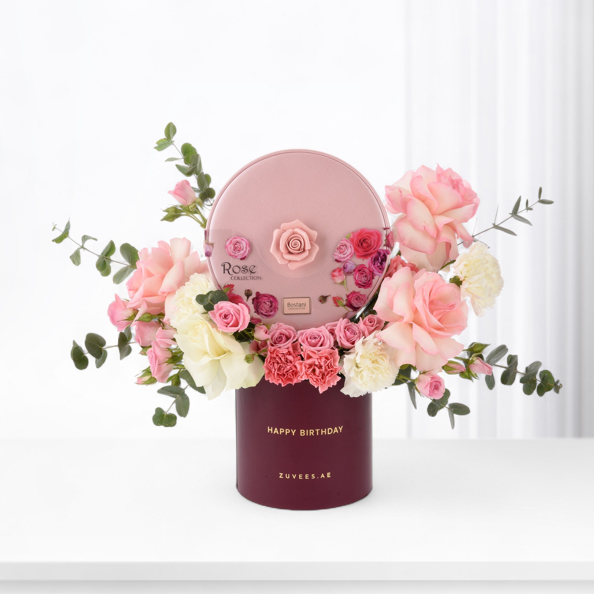 Pink rose bouquet in burgundy box with "Happy Birthday" text.