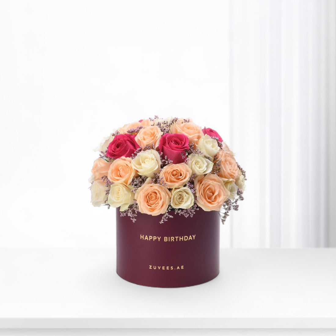 Vibrant multi-toned roses in burgundy box with "Happy Birthday" text.
