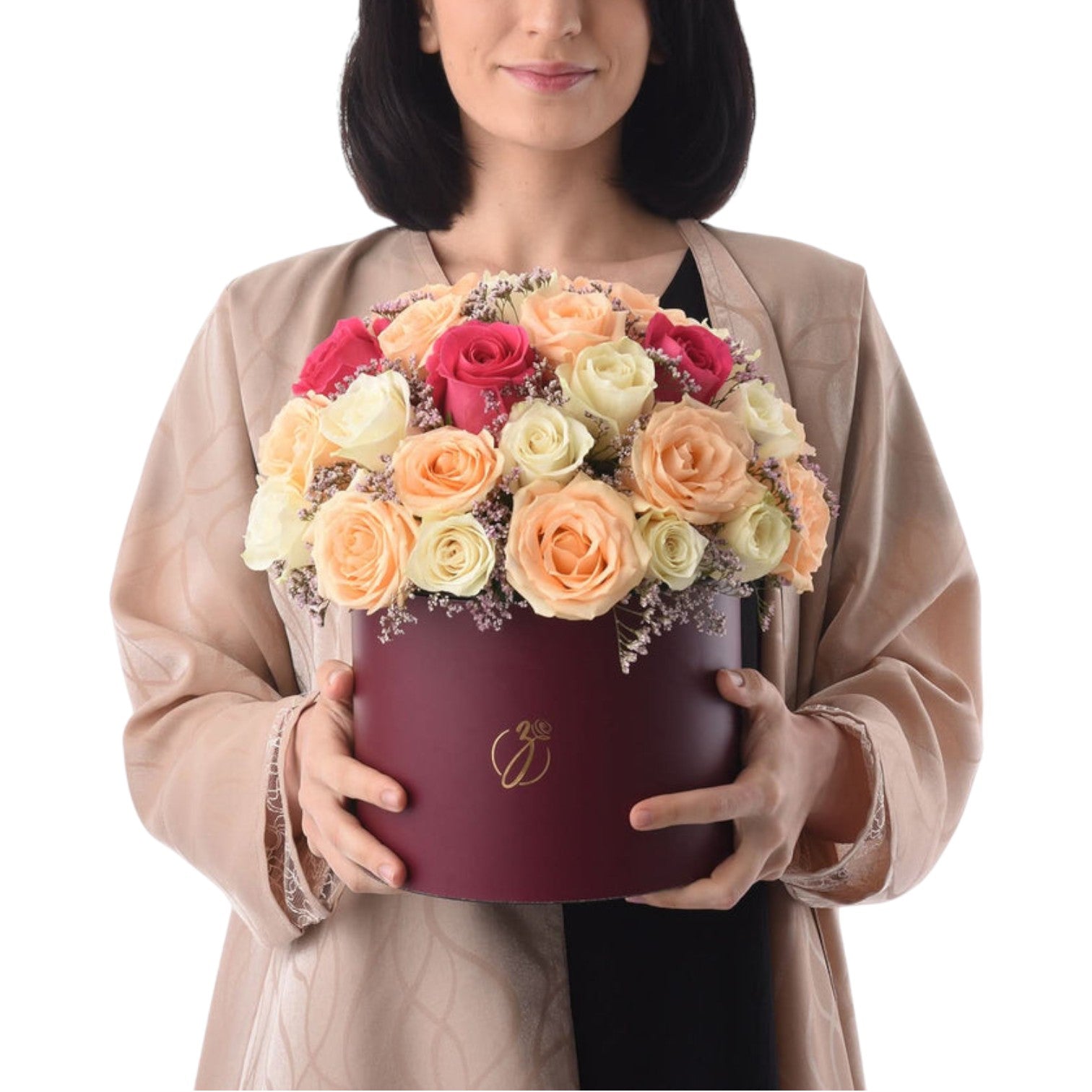 Woman holds burgundy hat box filled with vibrant multi-colored roses.